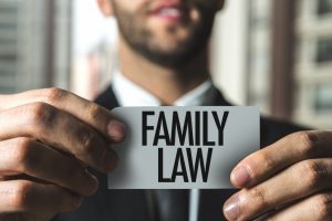 Lawyer holding a note with written text as family law