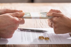 Divorce agreement contract with couple fighting over money